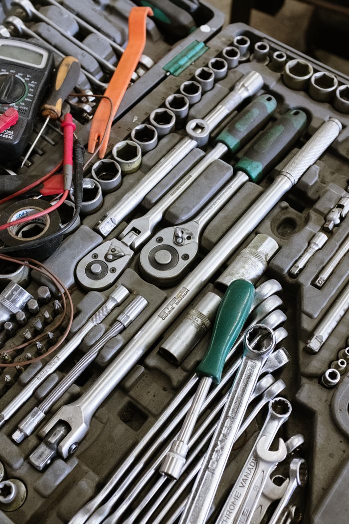 gallery-3 Detailed photo of various mechanic tools organized in a workshop setting. Perfect for repair themes.