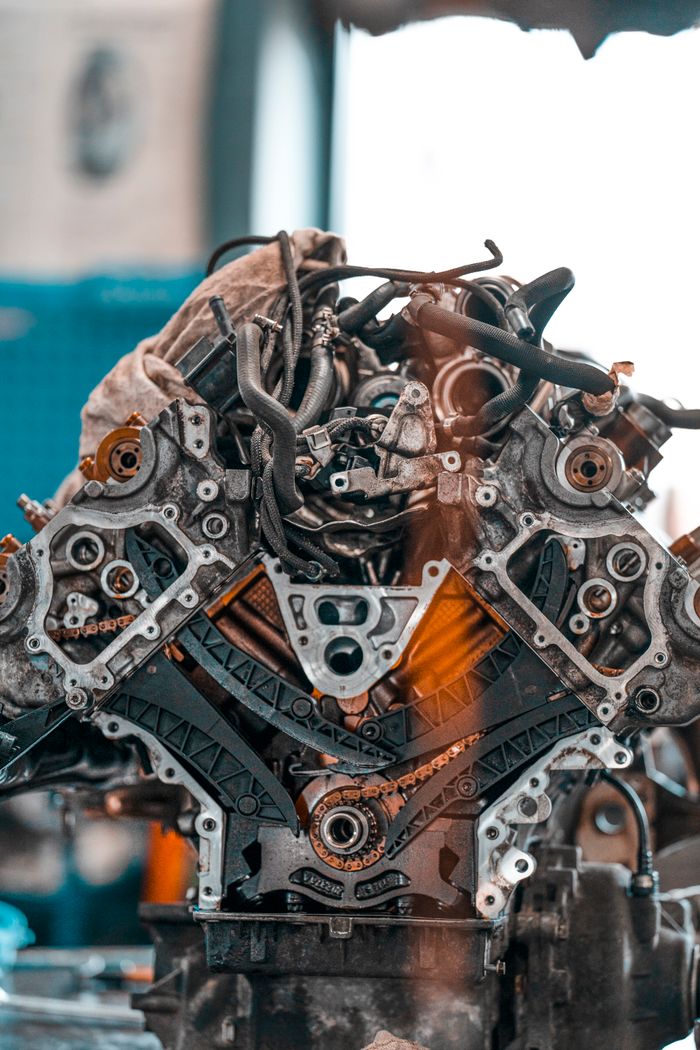 gallery-2 Car engine with various metal details placed on workbench in modern repair service